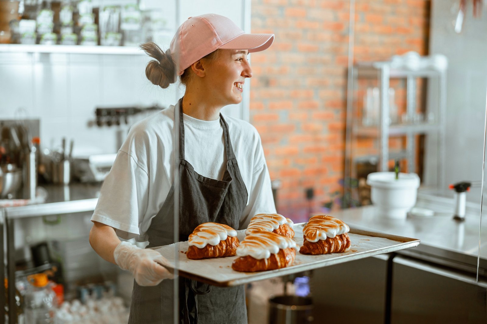 pretty-woman-baker-holds-beautiful-croissants-with-burnt-albumenous-cream-in-shop.jpg